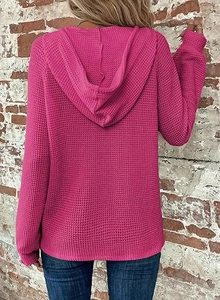 Detail view of the rose pink waffle knit fabric on women long sleeve hooded sweatshirt