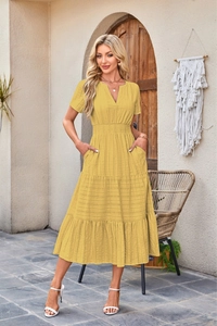 Detail of V-neck ruffled yellow tiered dress with puff sleeves and elastic waist