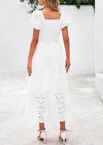 Back view of a white square neck tiered dress with floral eyelet embroidery and puff sleeves