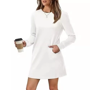 White long sleeve crewneck dress with front pockets and relaxed A-line silhouette
