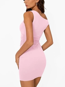 Close-up of ruched side detailing on a soft pink one-shoulder bodycon mini dress
