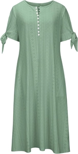 Detail of light green eyelet dress featuring small buttons and tied ribbon cuffs