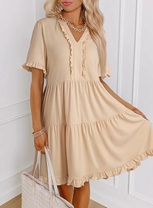 Close-up of v-neck tiered mini dress with ruffled sleeves in beige woven fabric