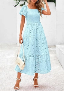Detail of light blue eyelet embroidery fabric and smocked bodice on square neck dress