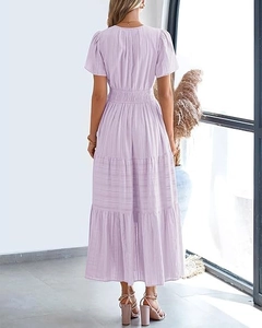 Detail of lavender tiered dress featuring puffy short sleeves and textured fabric
