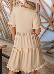 Detail of a beige tiered mini dress with ruffle sleeves and layers in a soft fabric