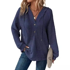 Women's blue waffle knit hoodie with V-neck button detail and adjustable drawstring hood