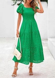 Detail of square neck and puff sleeves on a bright green eyelet embroidered dress