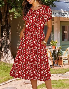 Close-up of red floral A-line dress with petal sleeves and side pockets in outdoor sunlight