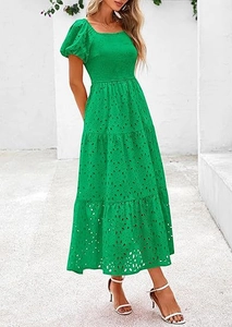 Detail of square neck and smocking texture on the green tiered eyelet summer dress