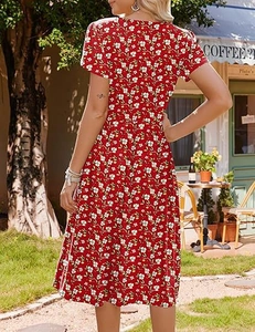 Detailed close-up of a red floral midi dress with white petal patterns and short sleeves