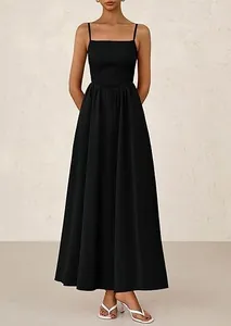 Detail of elegant black maxi dress featuring a pleated bodice and thin spaghetti straps
