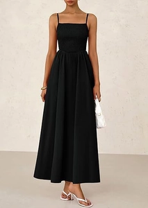 Detail of black spaghetti strap dress featuring a smocked bodice and elegant A-line silhouette