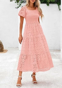 Close-up of pink tiered boho dress featuring floral embroidery and puff sleeves