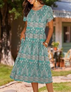 Detailed view of paisley print dress in lake green with practical side pockets and elastic waist