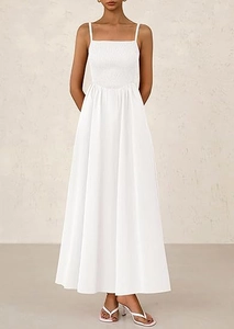 Elegant white pleated camisole dress with thin straps and a full A-line long skirt
