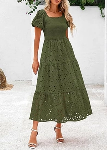 Close-up of dark green square neck dress showing intricate eyelet embroidery and smocked bodice