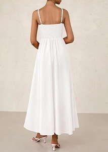 Detail of smocking on white maxi dress with adjustable thin spaghetti straps