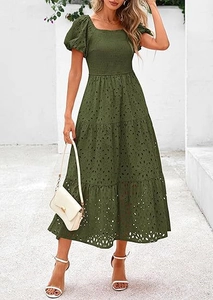 Detail of dark green square neck dress with puff sleeves and eyelet embroidery texture