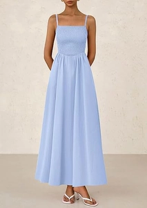 Detail of light blue smocked maxi dress with thin straps and ruffled bodice