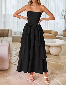 Detail of smocked elastic bodice and tiered layers on a black strapless maxi dress