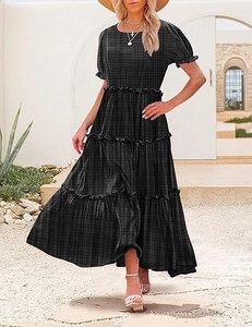 Detail view of tiered plaid dress featuring bubble short sleeves and ruffled hem design