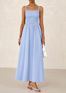 Detail of light blue smocked maxi dress with thin straps and airy pleated fabric