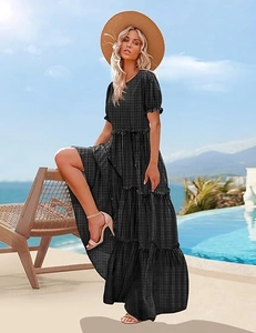 Detail of tiered plaid maxi dress with puff sleeves and ruffled hem for summer vacation