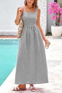 Detail of elegant black and white gingham maxi dress with square neck and high waist style