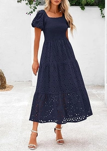 Close-up of navy blue tiered dress featuring eyelet embroidery and smocked bodice detail