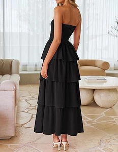 Side view of a tiered black strapless maxi dress with elegant layered ruffle skirt details