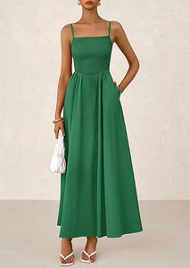 Macro detail of the smocked chest and delicate spaghetti straps on this green maxi dress