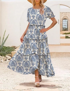 Detail of the tiered maxi dress with blue and white damask print and puff sleeves