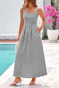 Detailed close-up of a black and white gingham maxi dress with side pocket and pleated skirt