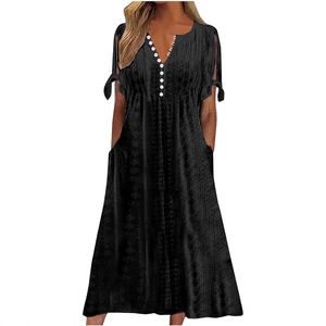 Women's black V-neck eyelet dress with buttons, tie-cuffs, and side pockets in a loose fit