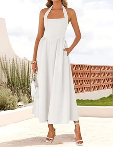 Detailed view of white halter neck midi dress with elegant high waist and side pockets