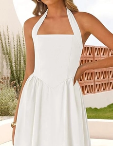 Detail of white halter neck dress featuring square collar and V-shaped waist stitching