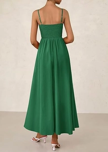 Detailed back view showing the smocked elastic bodice of a dark green maxi dress