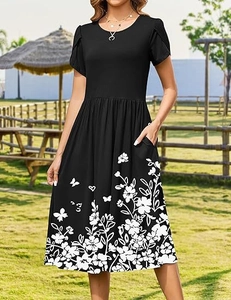 Detail of floral butterfly print on a black knee-length dress with side pockets
