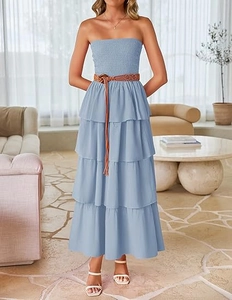 Close-up of light blue tiered maxi dress with smocked bodice and brown woven belt