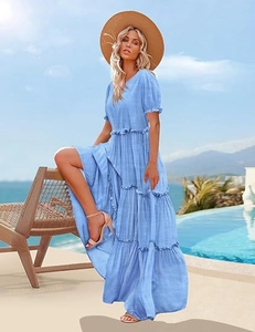 Detail of a sky blue tiered maxi dress featuring puff sleeves and ruffled layered skirt