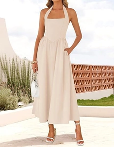 Detail view of beige halter neck maxi dress with high waist and side pockets for vacation