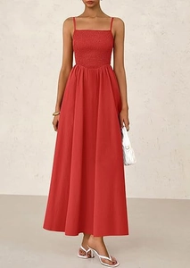 Detail of red spaghetti strap maxi dress with smocked bodice and pleats in a modern style