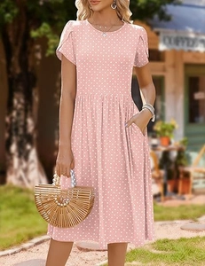 Detail of pink polka dot dress showing tulip sleeves and functional side pockets