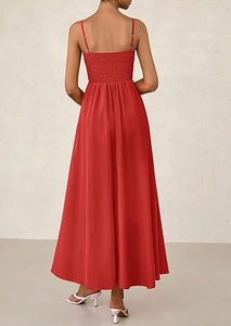 Detail of red summer maxi dress featuring a smocked elastic back and thin straps
