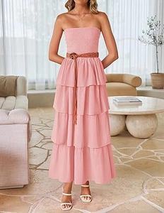 Detail view of pink smocked tube maxi dress with layered ruffles and brown braided belt