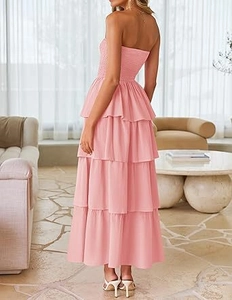 Detail of light pink tiered maxi dress featuring a smocked bodice and layered ruffle skirt