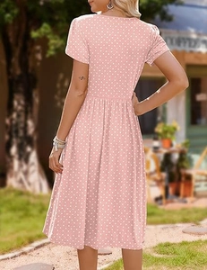Detail view of pink polka dot dress showing back tailoring and floral petal sleeves