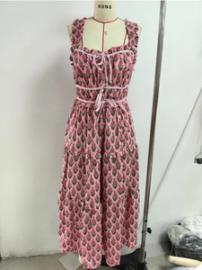 Detail of pink floral maxi dress featuring ruffled straps and lace-up bodice front