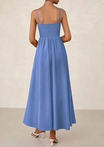 Detail of the smocked elastic back on the light blue spaghetti strap maxi dress